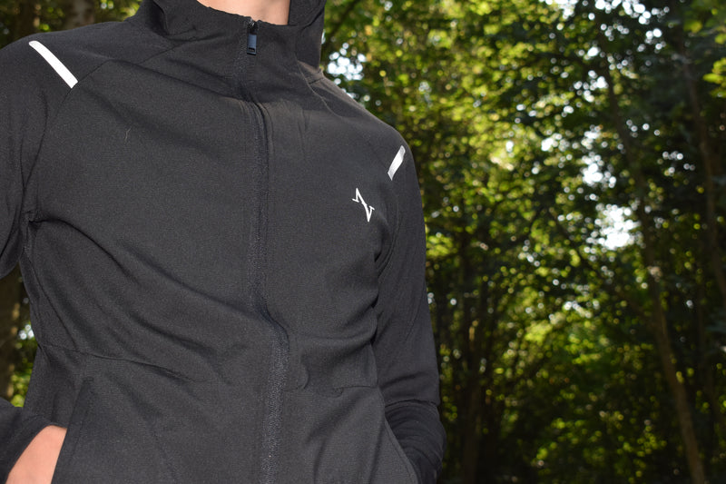 Men's Performance Jacket - Full Zip Design shown in black with minimalist logo, ideal for lightweight warmth during outdoor training or layering.